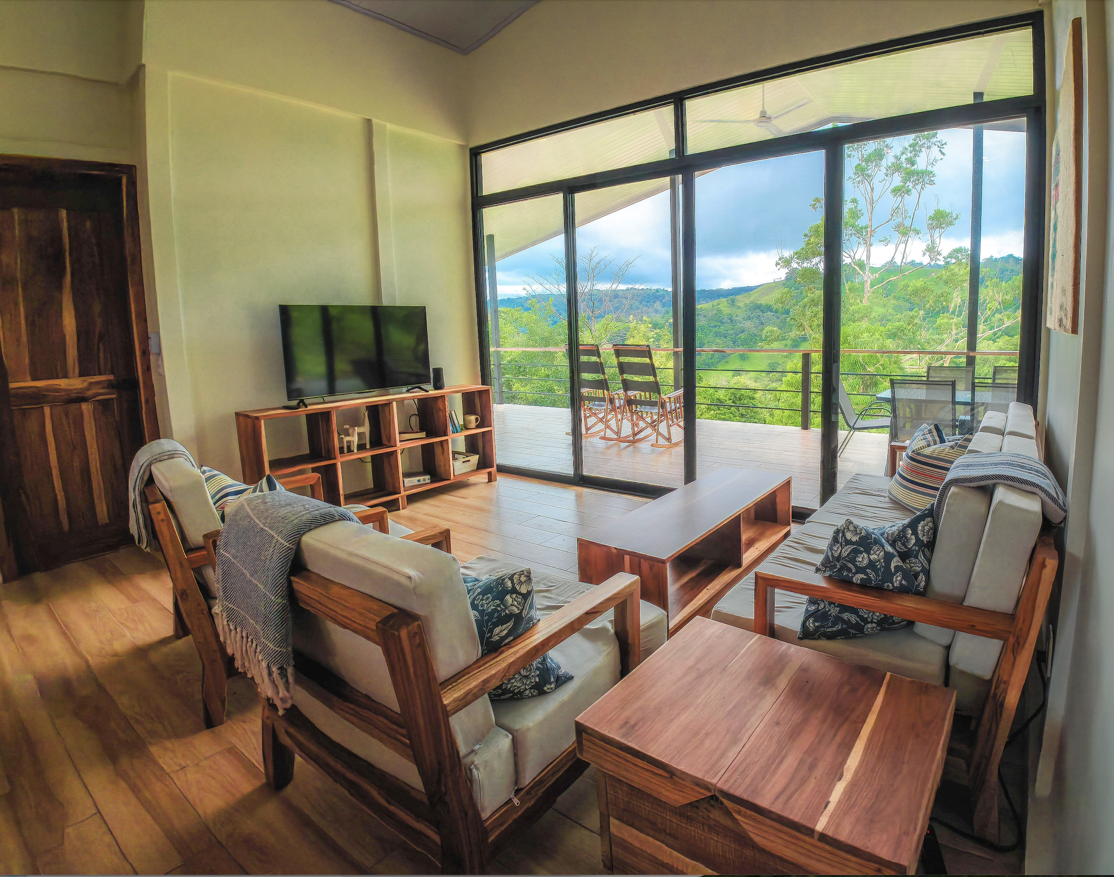 Living room facing the deck and green hills beyond