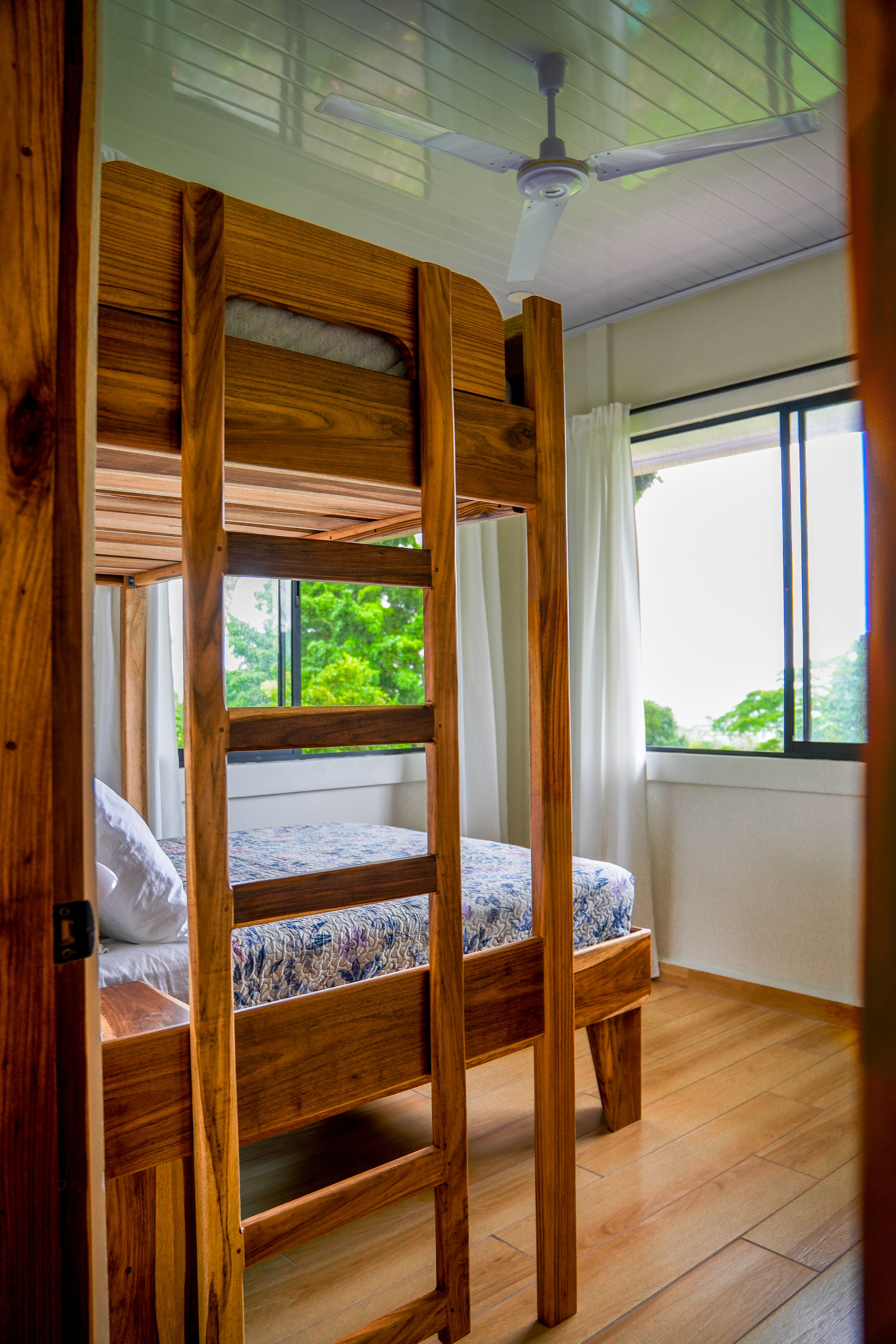 Bunk bedroom with teak bunk and view to the trees