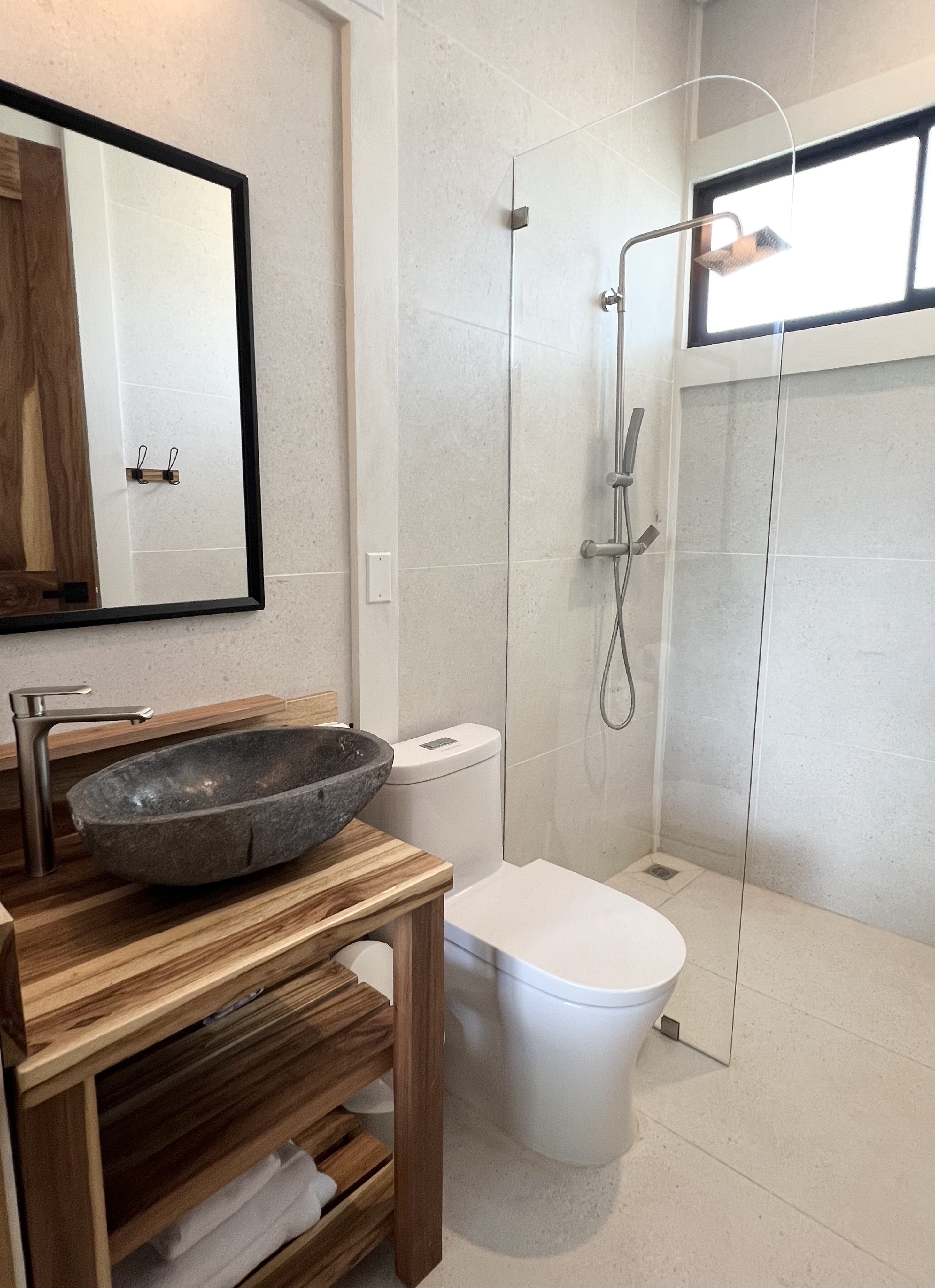 Bathroom with stone vessel sink and walk-in shower